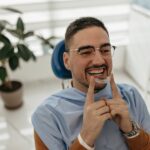 Man wearing invisalign trays in dental chair